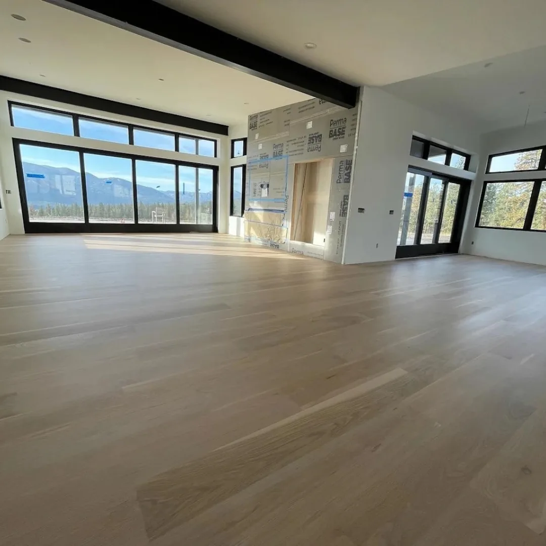 Newly installed light hardwood floor in spacious room