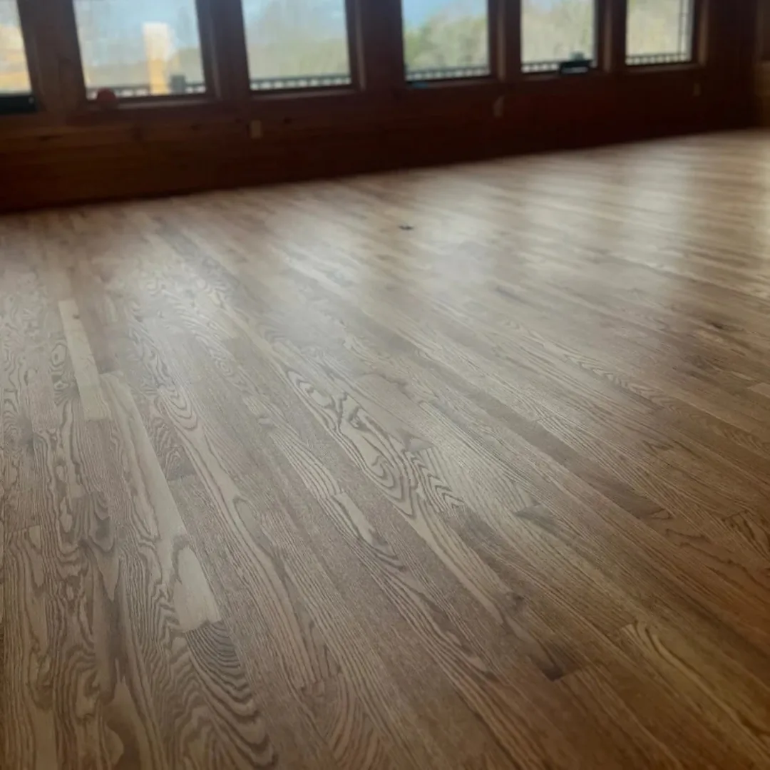 Newly refinished hardwood floor with natural light