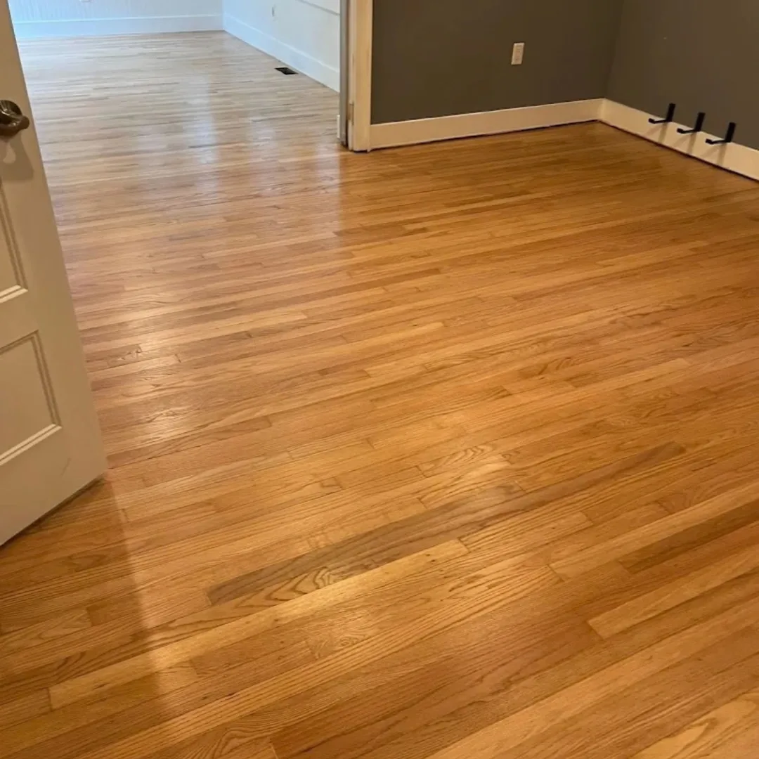 Refinished hardwood floor with natural wood grain.