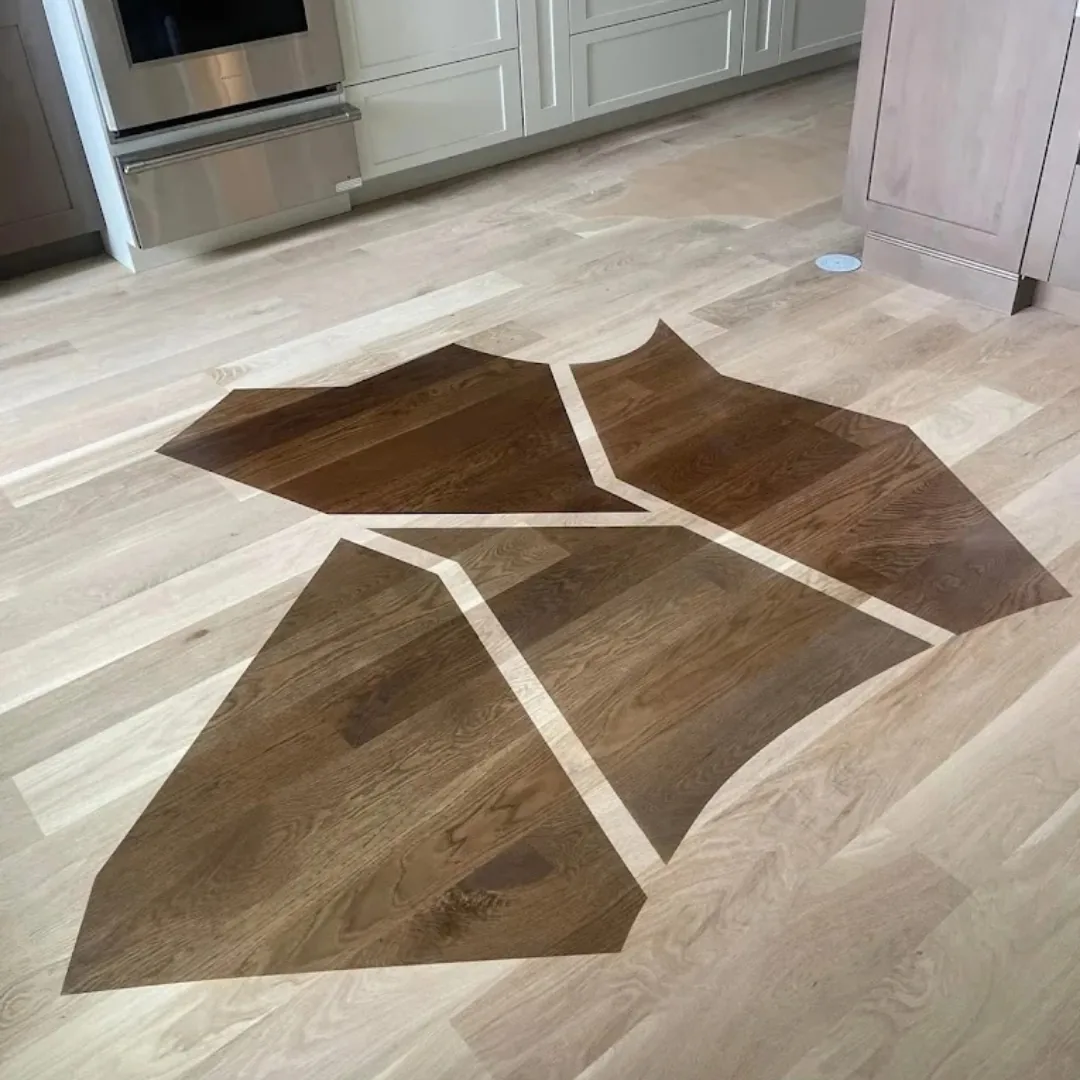 Hardwood floor with custom geometric dark inlay.