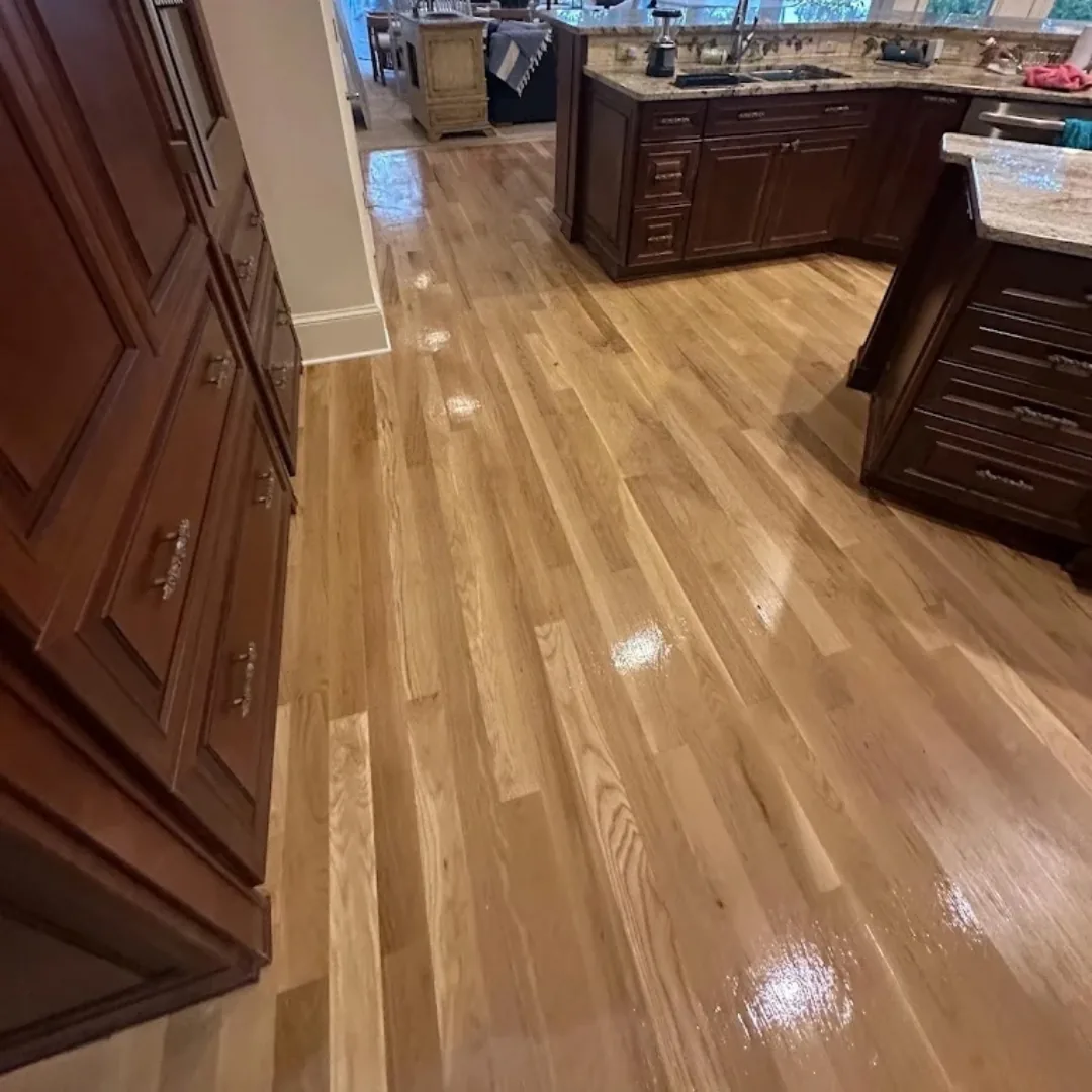Newly refinished hardwood floors in a kitchen.