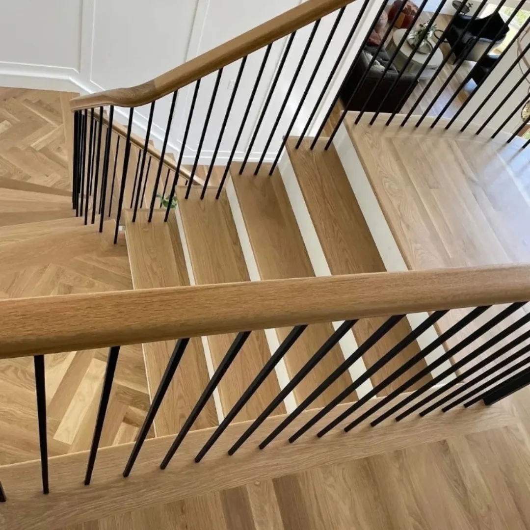 Modern hardwood staircase with black metal railings