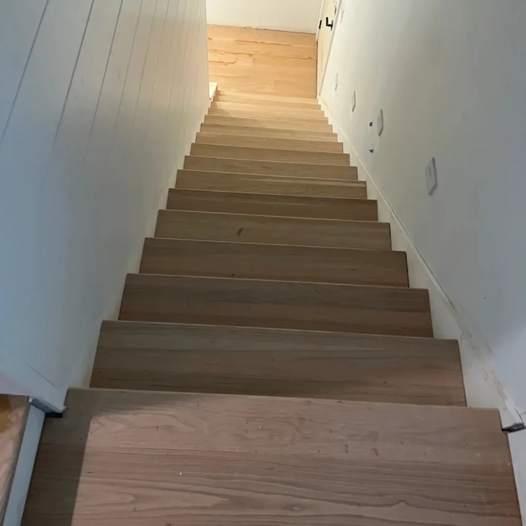 New hardwood staircase installation in light wood.
