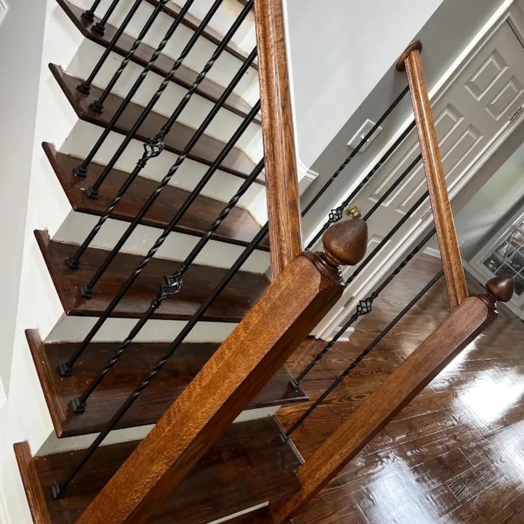 Refinished hardwood stairs with new wrought iron spindles