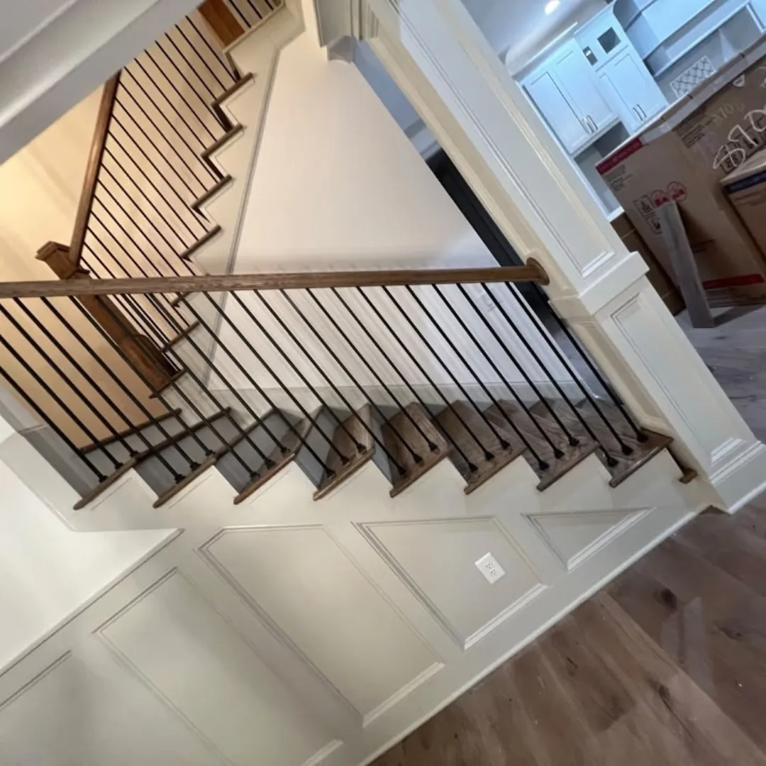 New hardwood stairs, iron balusters, wainscoting.
